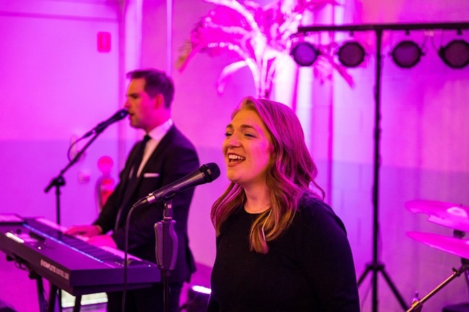 A person singing into a microphoneDescription automatically generated with medium confidence